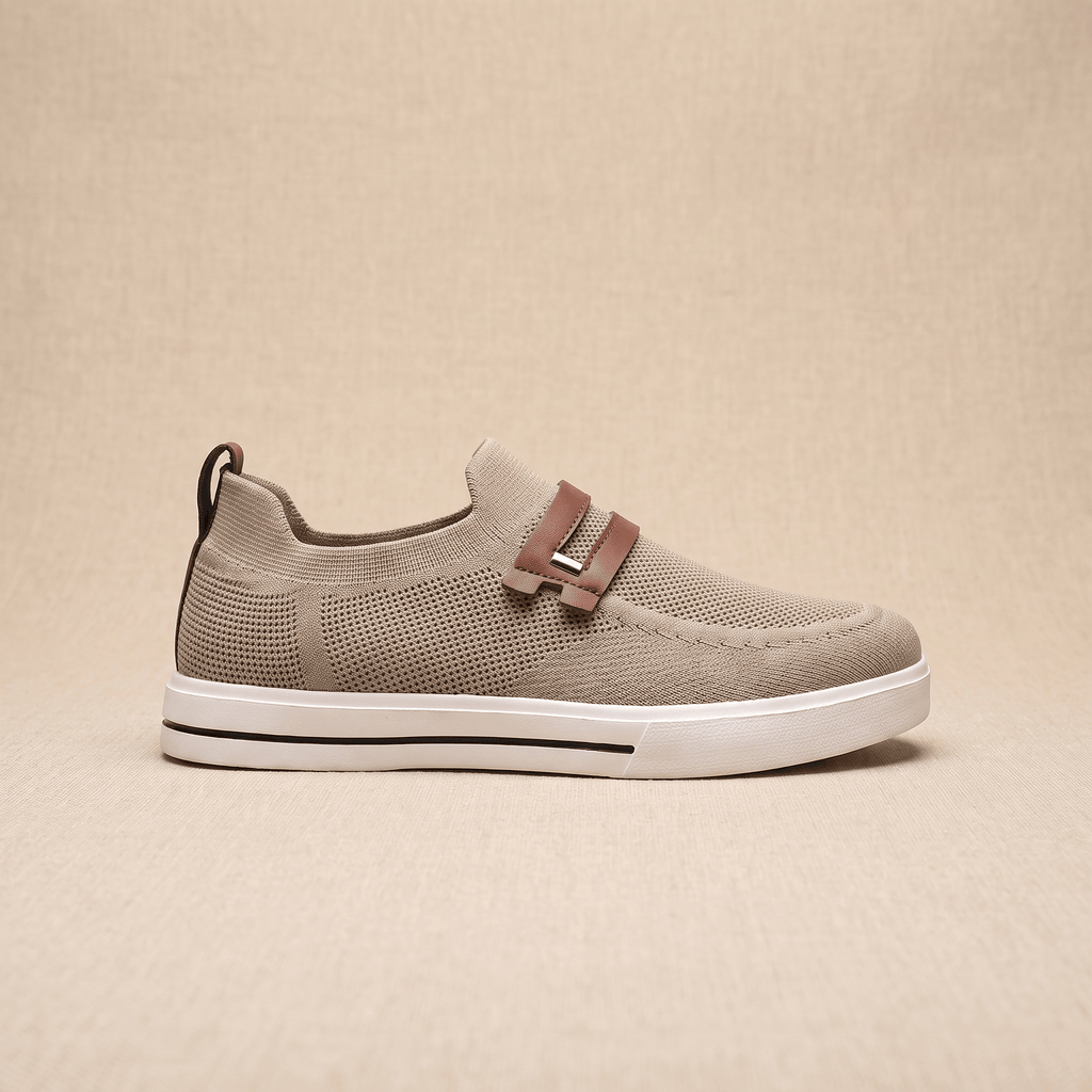 Side profile of a single khaki mesh Orion sneaker with brown leather strap, resting on a beige surface