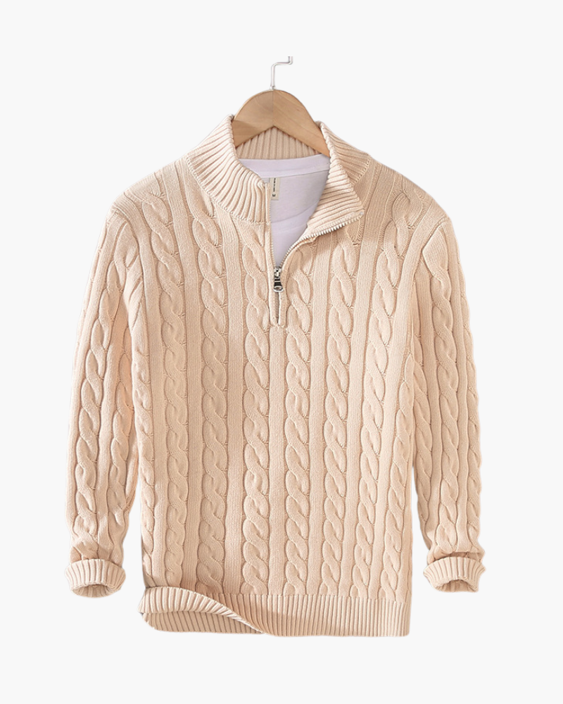 Beige cable knit quarter-zip sweater with a stand collar and ribbed cuffs displayed on a wooden hanger.