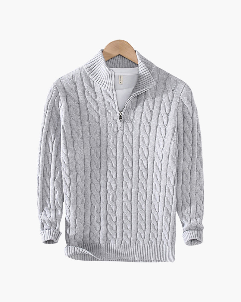 Light gray cable knit quarter-zip sweater with a stand collar and ribbed cuffs displayed on a wooden hanger.