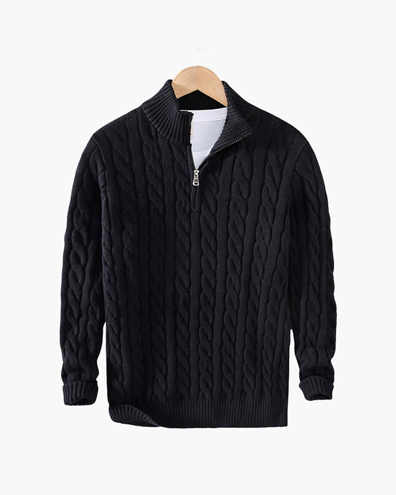 Black cable knit quarter-zip sweater with a stand collar and ribbed cuffs displayed on a wooden hanger.