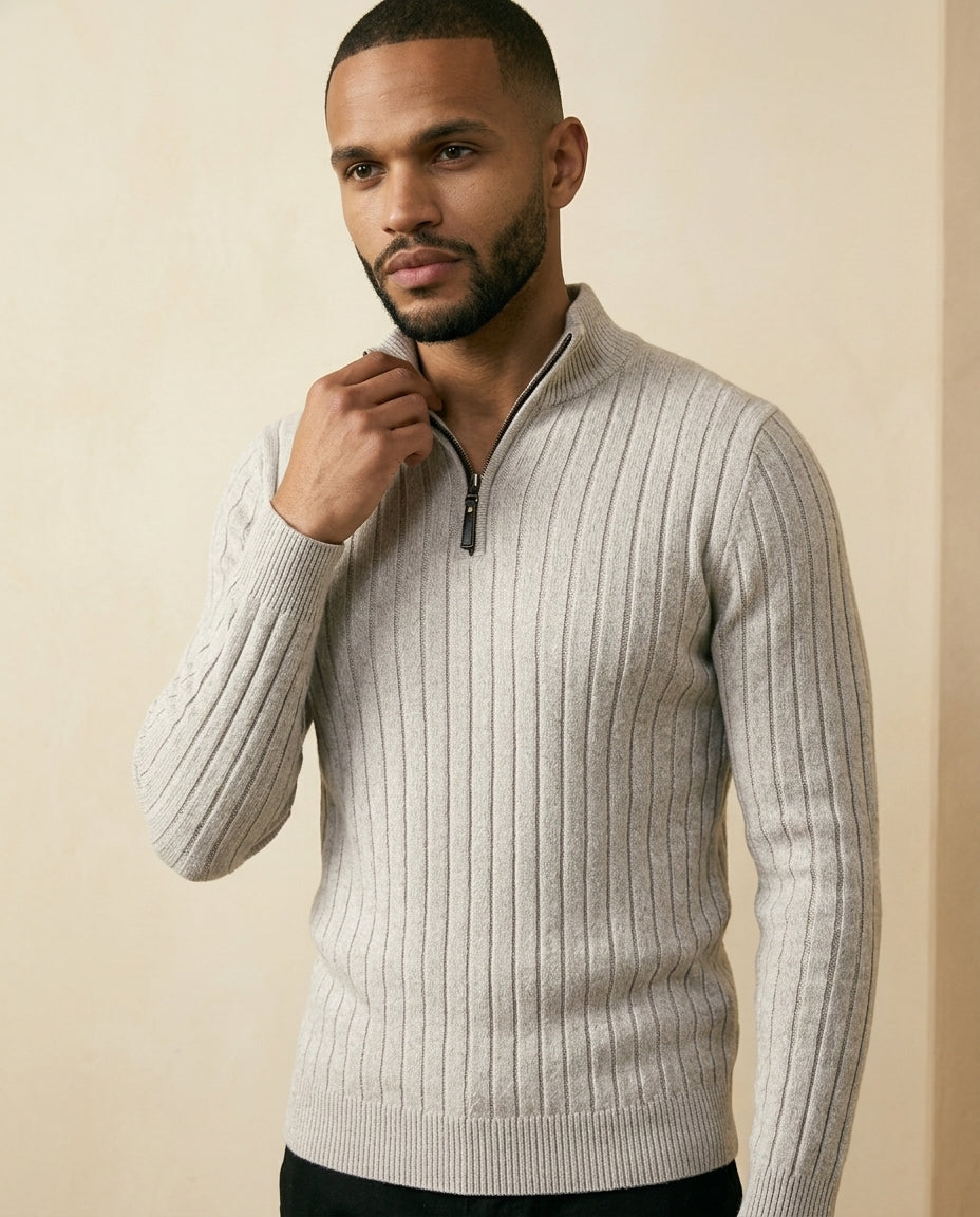 Light grey ribbed quarter-zip sweater with a stand collar and soft, brushed texture worn by a man.