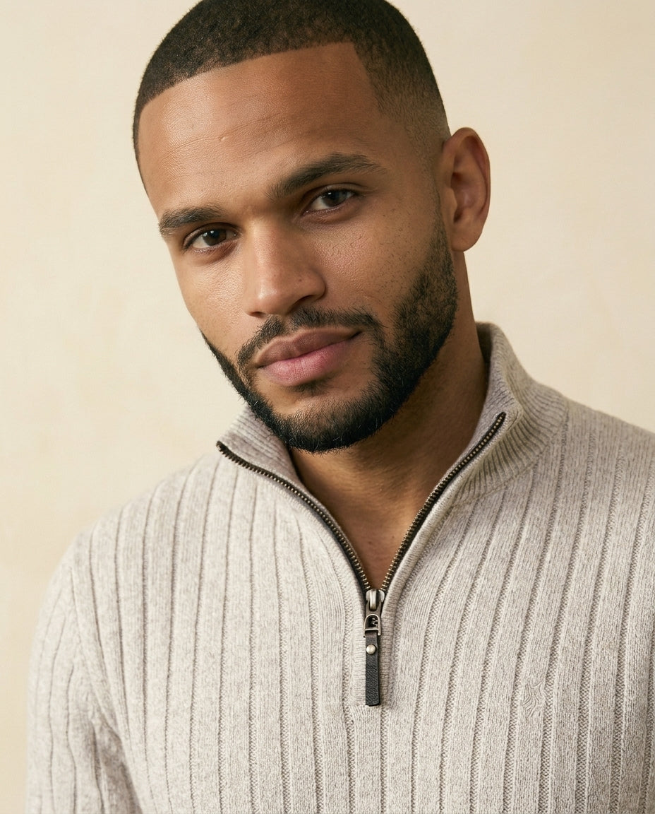 Beige ribbed quarter-zip sweater with a stand collar and soft-touch brushed texture worn by a man.
