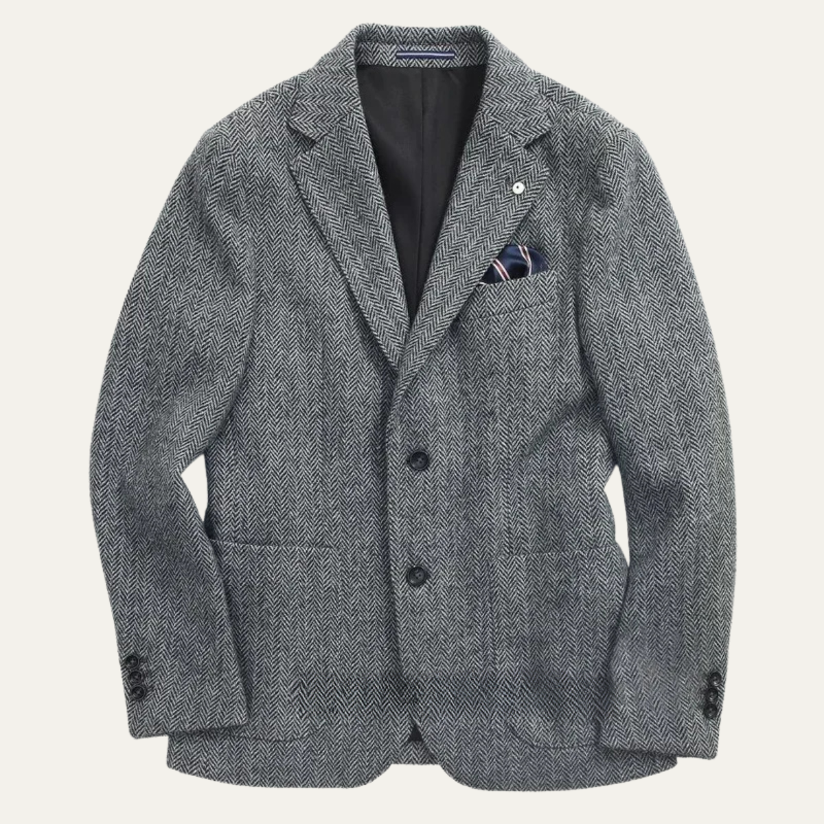 Men's grey herringbone tweed blazer with a notched lapel, two-button closure, flap pockets, chest pocket square, and tailored fit.
