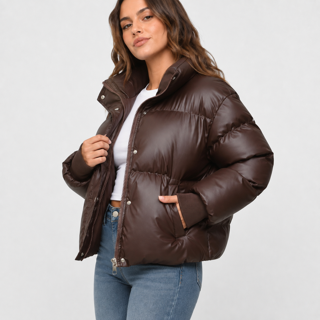 Dark brown oversized cropped puffer jacket with a stand collar, snap-over zip front, and ribbed cuffs.