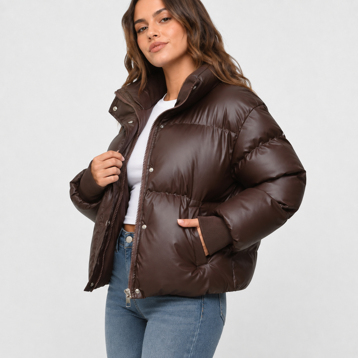 Dark brown oversized cropped puffer jacket with a stand collar, snap-over zip front, and ribbed cuffs.
