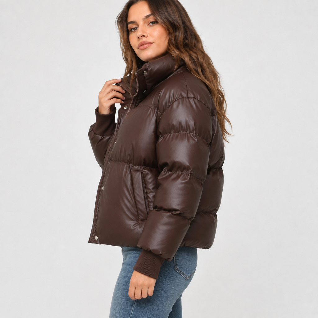 Dark brown cropped puffer jacket with a stand collar, snap-over zip front, and smooth, quilted finish.