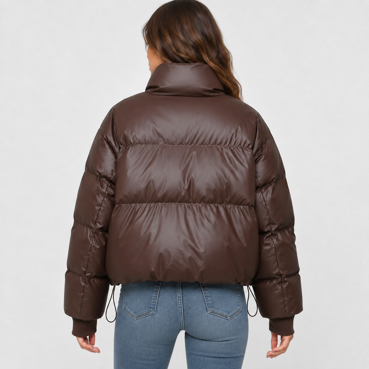 Dark brown cropped puffer jacket with a high stand collar, quilted padding, and a loose, oversized fit.