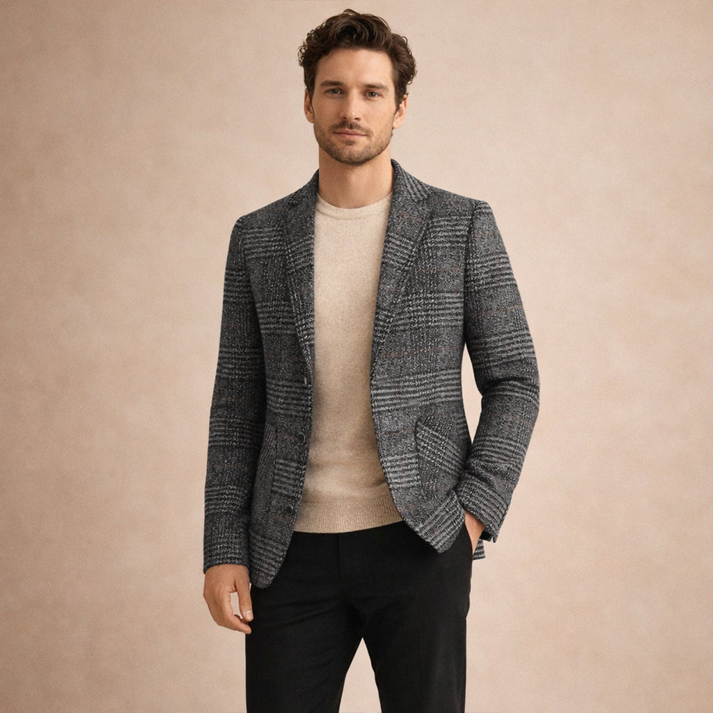 Man wearing a brown plaid tweed blazer featuring a notched lapel, two-button front, and tailored silhouette over a beige T-shirt.