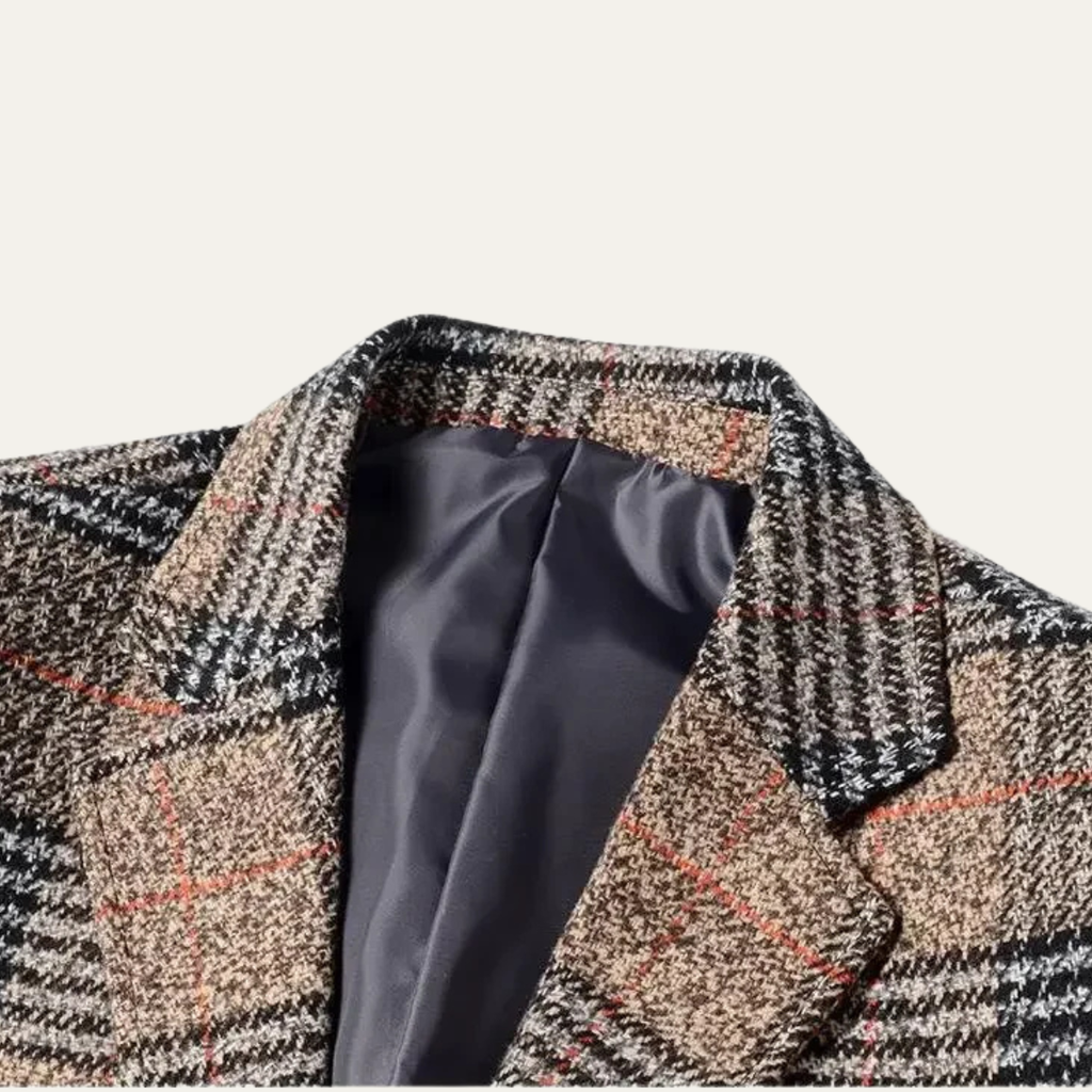 Close-up of the interior lining and notched lapel on a men's brown plaid tweed blazer.
