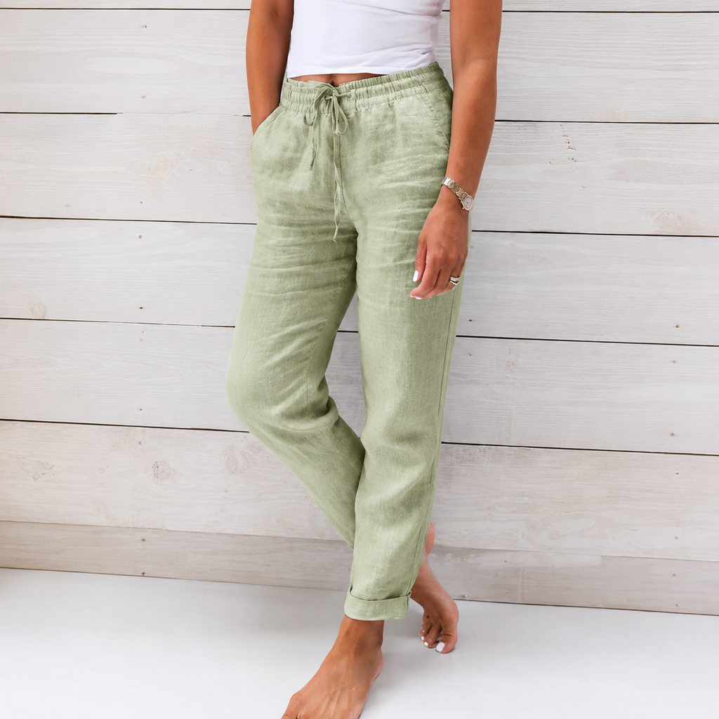 Women's sage green linen drawstring pants with an elastic waistband, tapered leg, and relaxed fit.