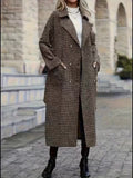 Longline plaid trench coat in brown and black with a double-breasted front, wide lapels, and a relaxed H-line fit.
