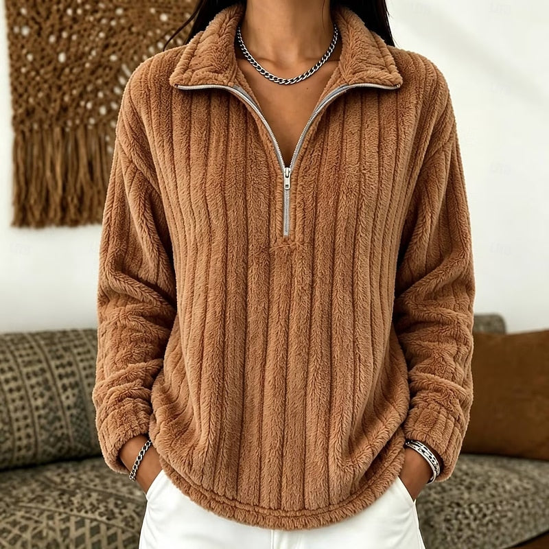 Tan plush ribbed half-zip pullover with a fold-over collar, drop-shoulder sleeves, and a relaxed fit.