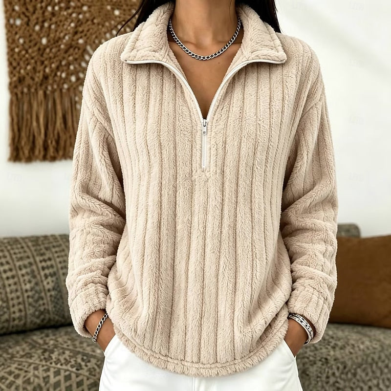 Beige plush ribbed half-zip pullover with a relaxed fit, fold-over collar, and drop-shoulder sleeves.
