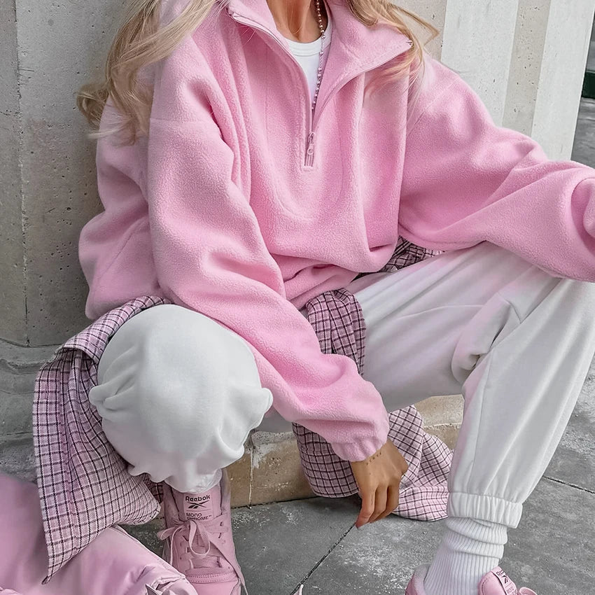 Close-up of pink quarter-zip fleece pullover worn by a female model