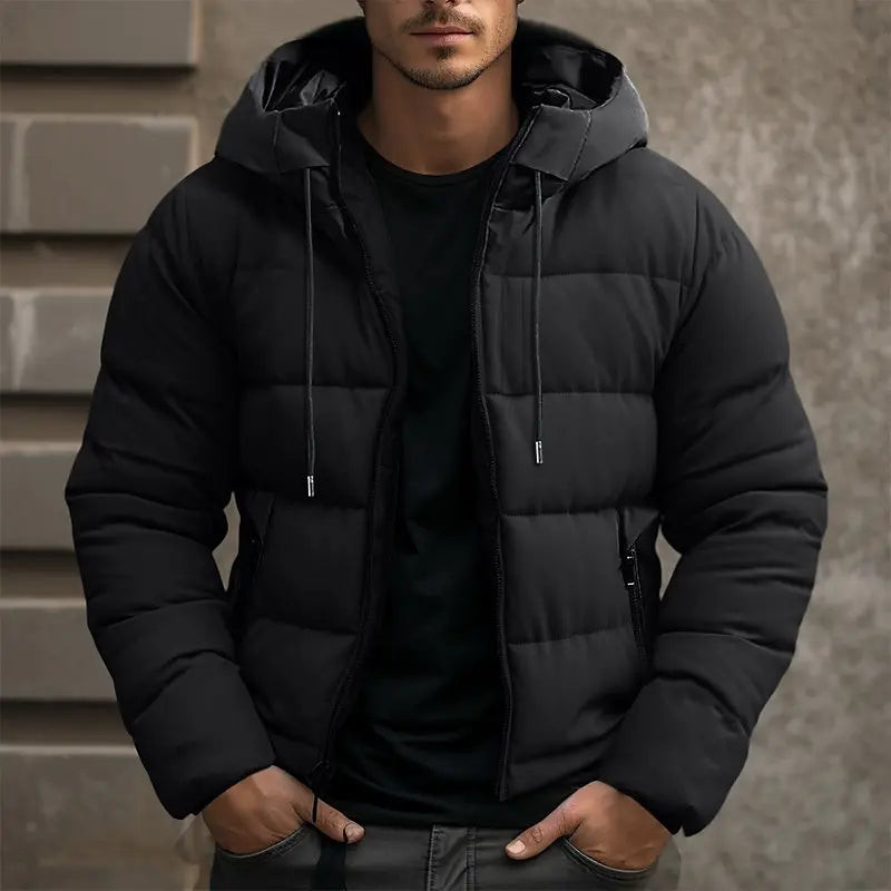 Black quilted puffer jacket with a drawstring hood, full-zip front, and tailored fit worn over a matching black shirt.