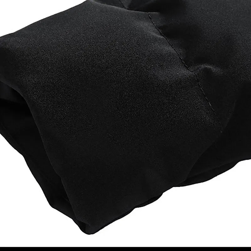 Black quilted puffer jacket sleeve with smooth, matte fabric and clean, padded channel stitching.