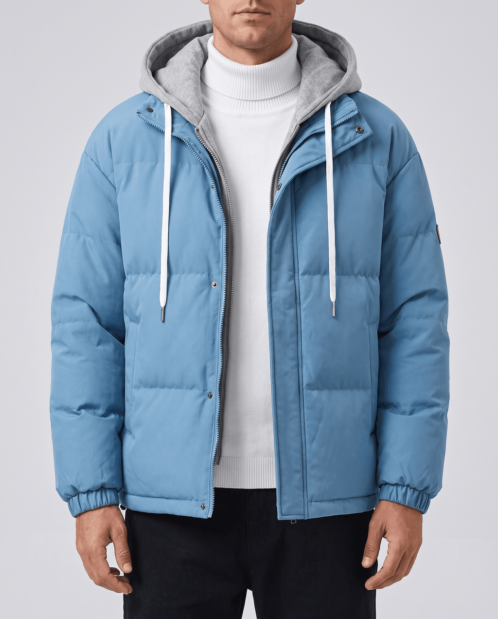 A man wearing a blue quilted hooded puffer jacket with drawstring hood and zip pockets
