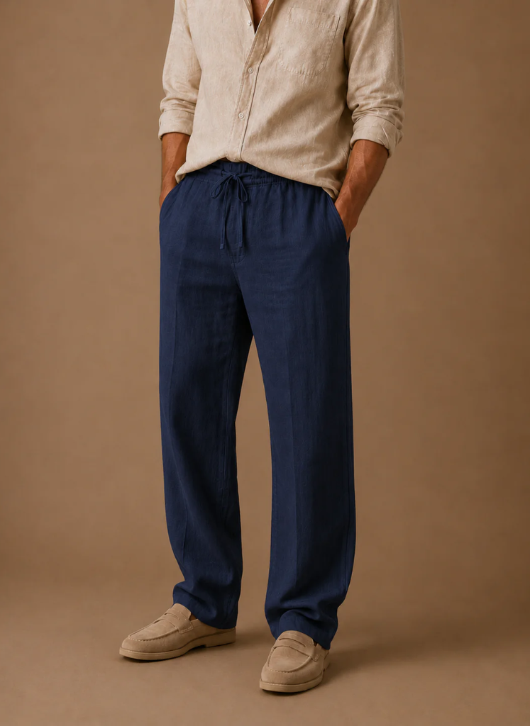 Man wearing navy linen drawstring pants with a relaxed straight-leg fit and lightweight breathable fabric.