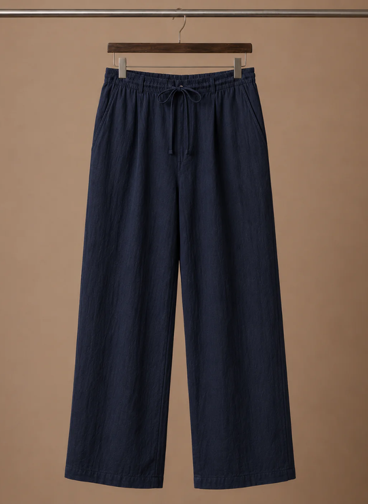 Men's navy linen drawstring pants with an elastic waistband and relaxed straight-leg silhouette displayed on a hanger.