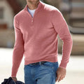 Pink half-zip knit sweater with a stand collar and long sleeves, worn with blue jeans in a casual outdoor setting.