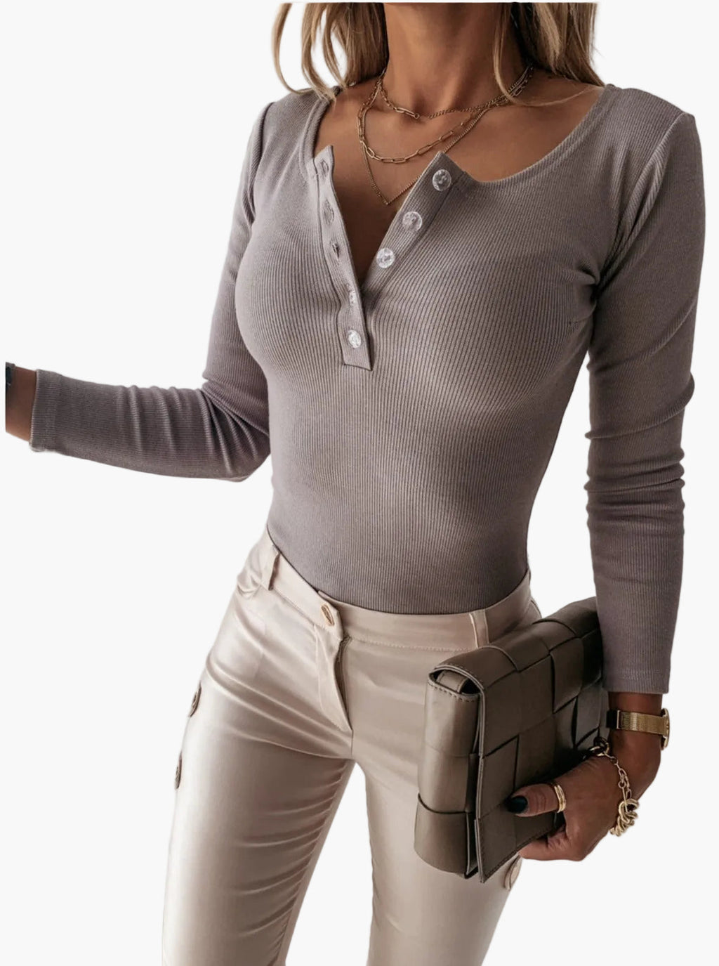 Woman wearing a taupe ribbed long-sleeve Henley top with a four-button placket, scoop neckline, and fitted silhouette.