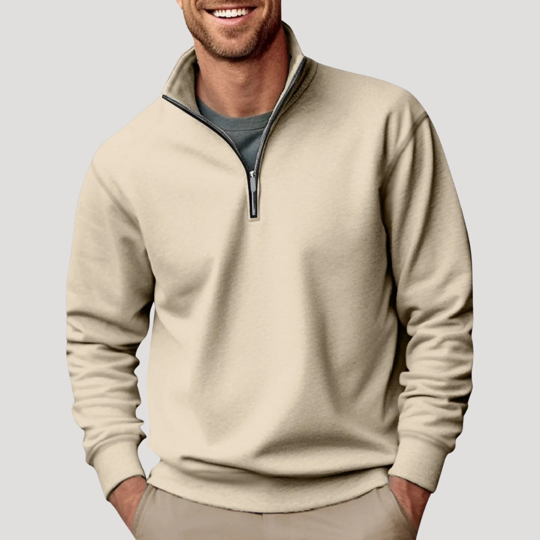 Beige relaxed-fit quarter-zip sweater in soft brushed fabric with a stand collar and ribbed cuffs worn over a grey tee.