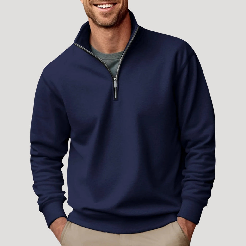 Navy blue quarter-zip sweater in brushed fabric with a stand collar, ribbed cuffs, and a relaxed fit worn over a tee.