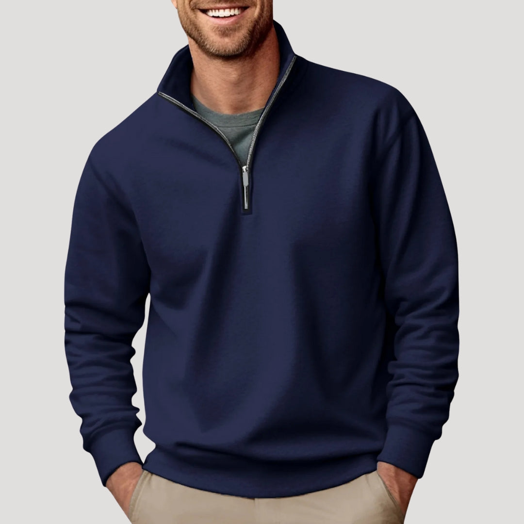 Navy blue quarter-zip sweater in brushed fabric with a stand collar, ribbed cuffs, and a relaxed fit worn over a tee.