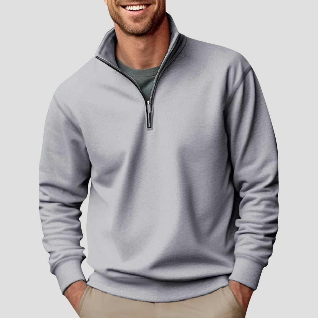 Light gray relaxed-fit quarter-zip sweater with a soft brushed finish, stand collar, and ribbed cuffs worn over a tee.