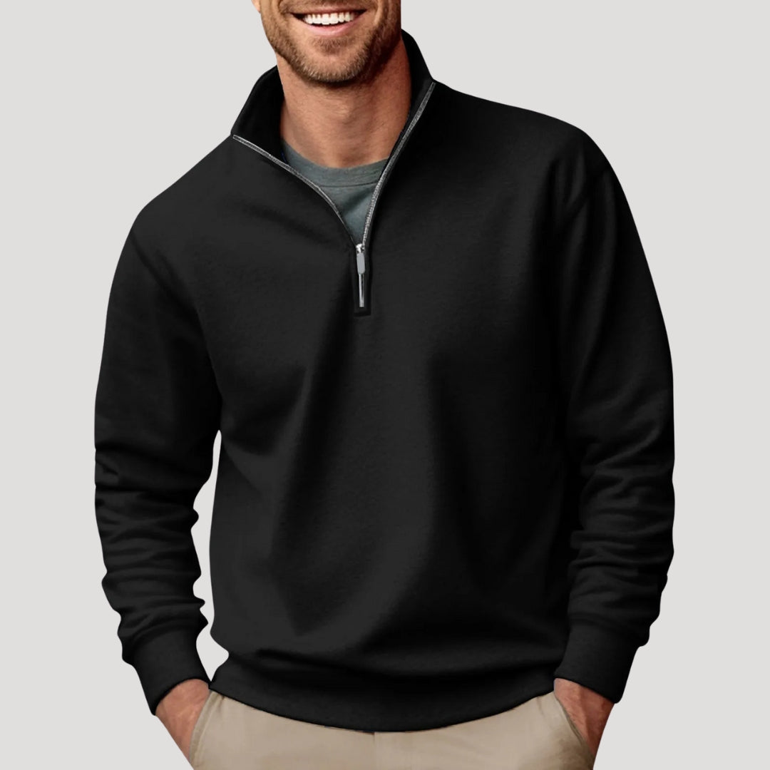Black relaxed-fit quarter-zip sweater with a soft brushed finish, stand collar, and ribbed cuffs worn over a grey tee.