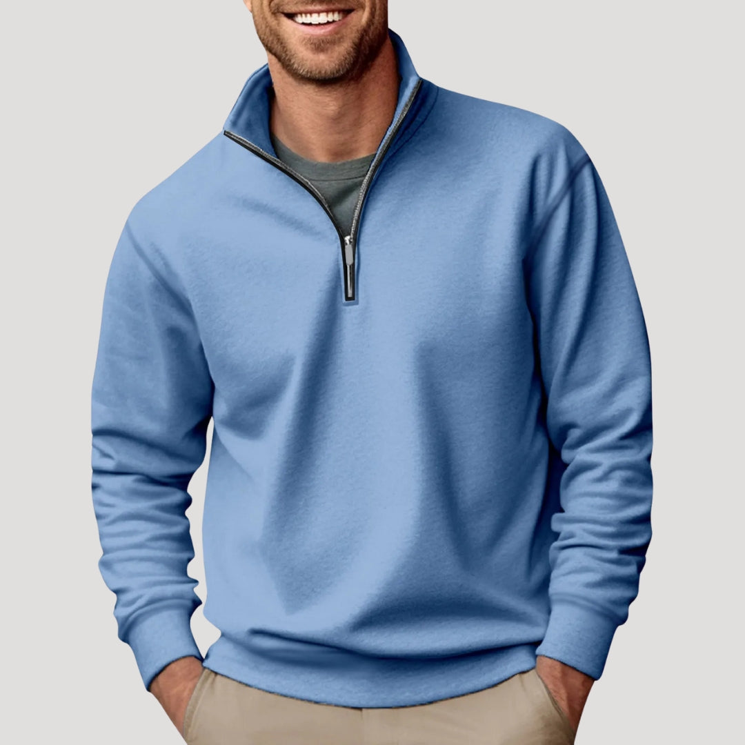 Light blue relaxed-fit quarter-zip sweater with a soft brushed finish, stand collar, and ribbed cuffs worn over a grey tee.