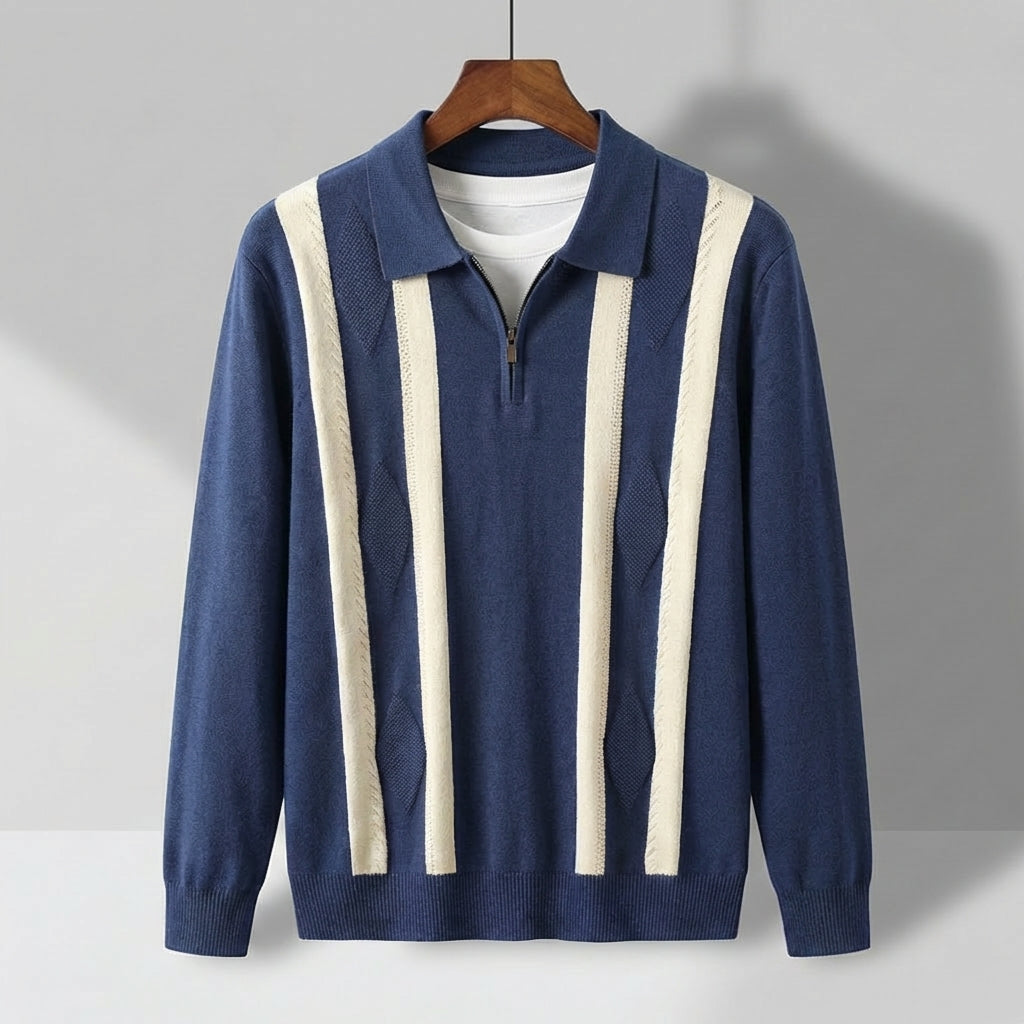 Blue long-sleeve knit polo with a quarter-zip collar, featuring cream vertical stripes and a textured diamond pattern.