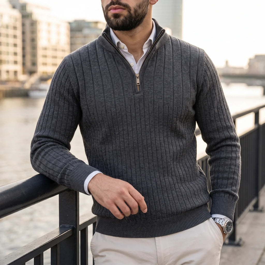 Charcoal grey ribbed knit quarter-zip sweater in a cotton blend, worn over a white collared shirt with a mock neck.