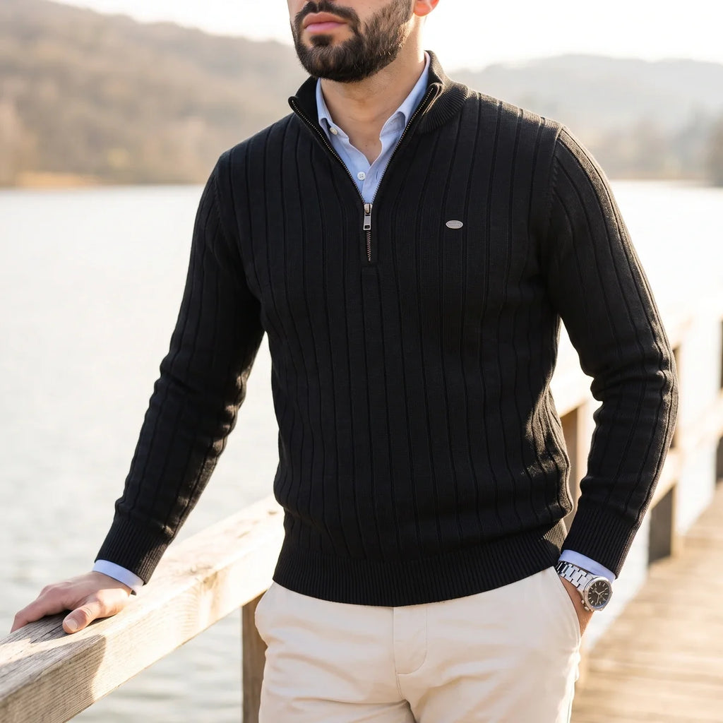 Black ribbed knit quarter-zip sweater in a cotton blend with a mock neck, layered over a light blue collared shirt.