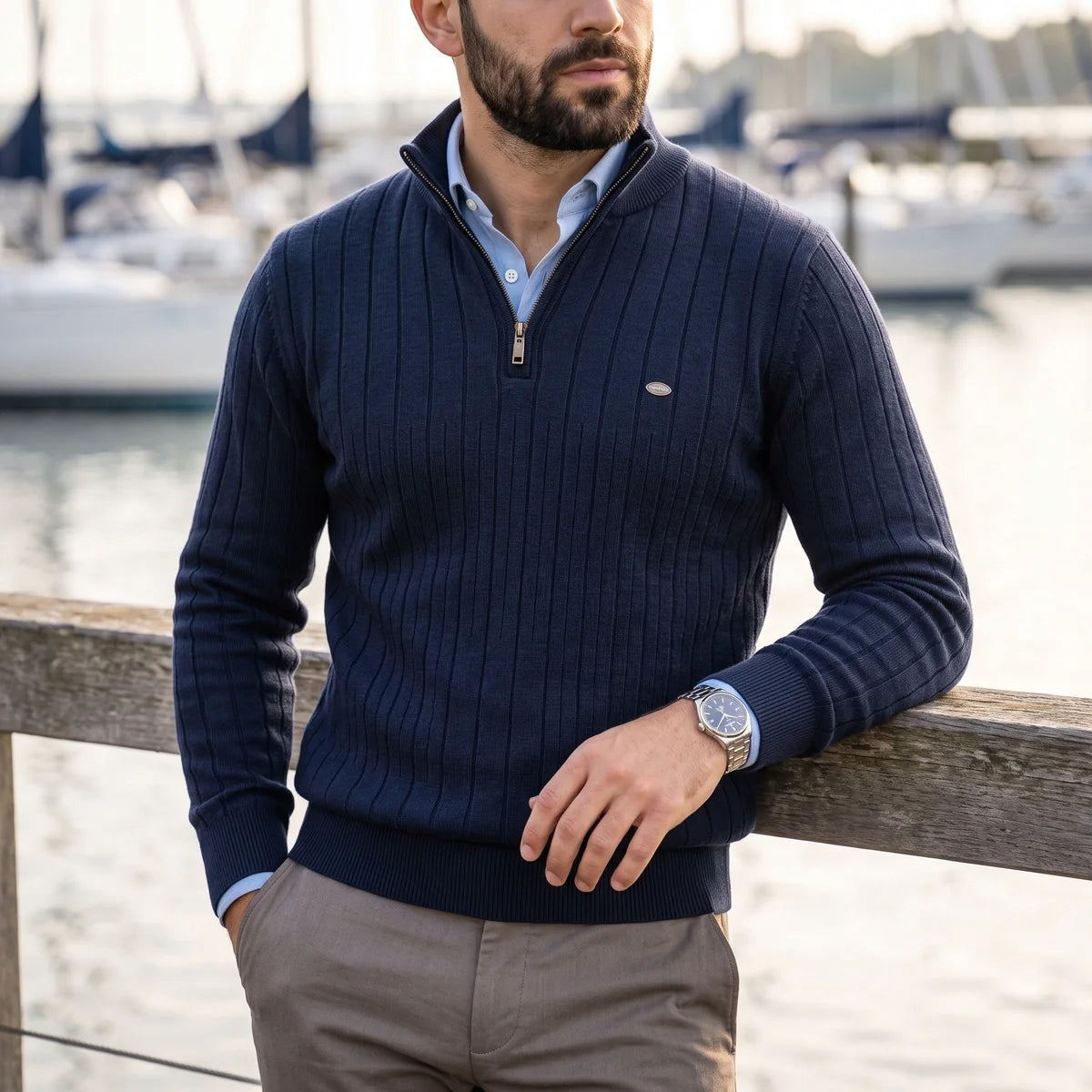 Navy blue ribbed knit quarter-zip sweater with a mock neck, layered over a light blue collared shirt by a marina.