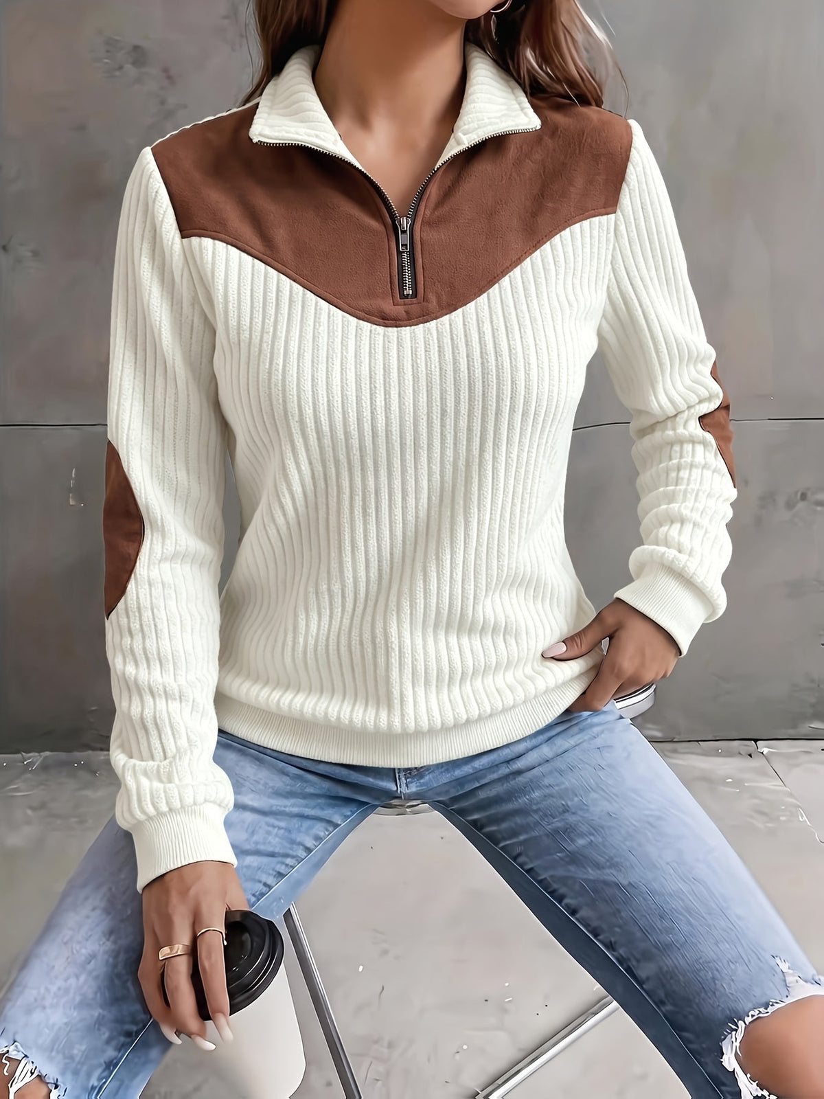 Cream ribbed knit quarter-zip sweater featuring a brown suede-look yoke and matching elbow patches.