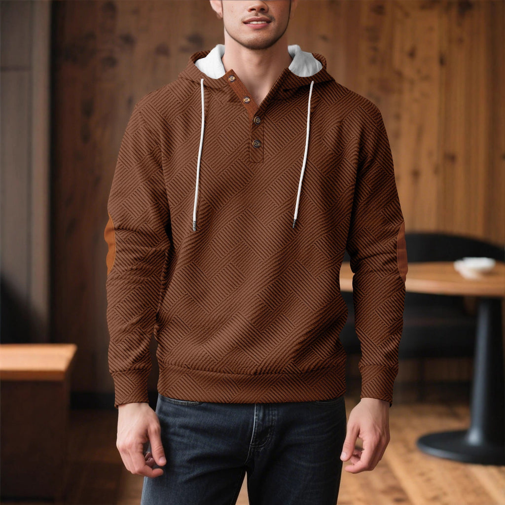 Man wearing brown textured button-placket hoodie and jeans, side profile view indoors