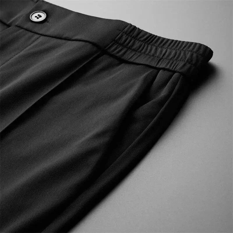 Close-up of the black elastic waistband with button closure for a comfortable fit.