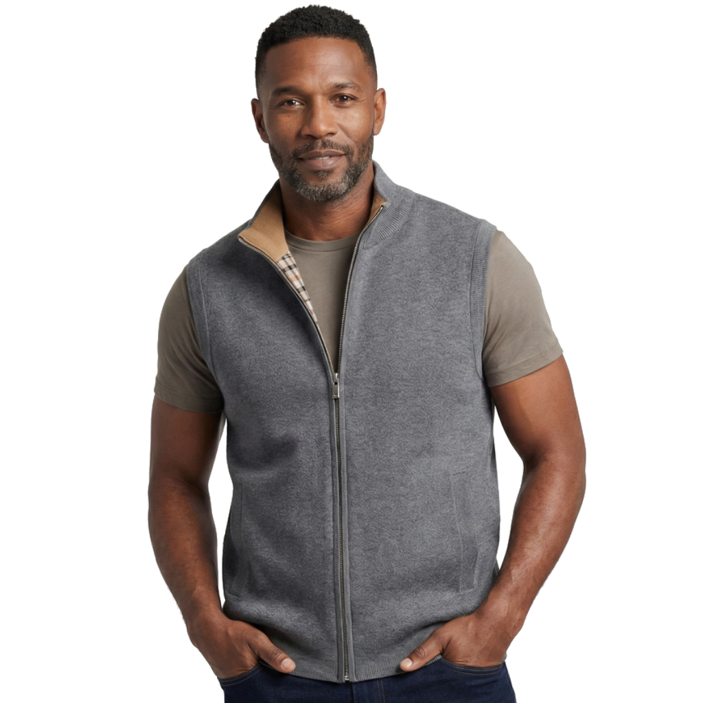 Man wearing a gray knit zip-up sweater vest with a stand collar, sleeveless design, and front zipper layered over a taupe T-shirt.