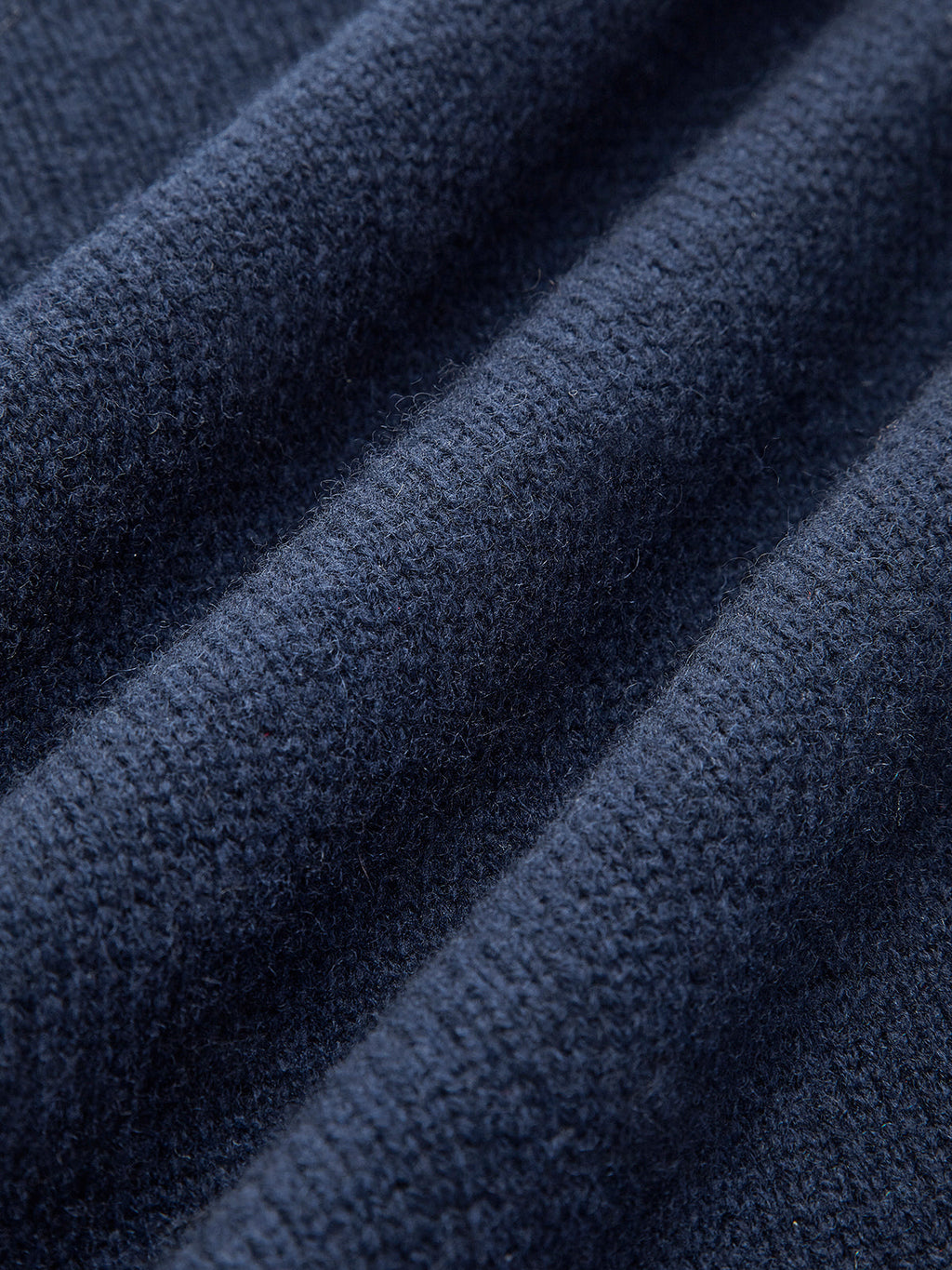 Close-up of the navy knit fabric highlighting the soft textured weave and premium finish.