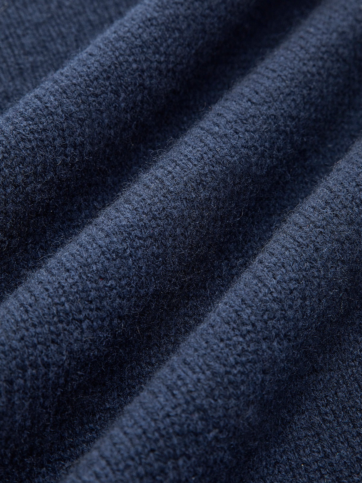 Close-up of the navy knit fabric highlighting the soft textured weave and premium finish.