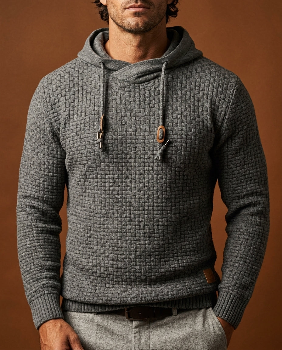 Man wearing grey textured knit hooded sweater with wooden toggle drawstrings, close-up front view