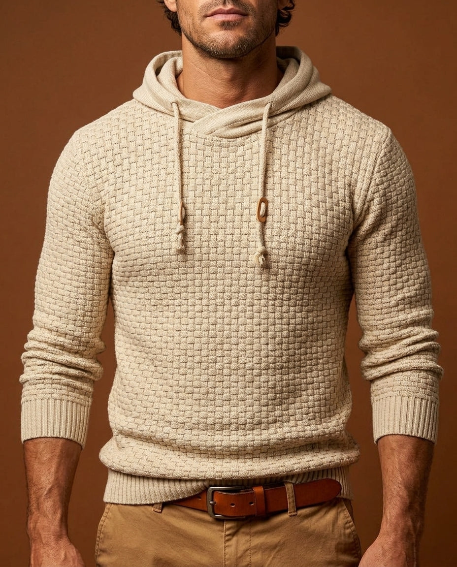 Man wearing beige textured knit hooded sweater with wooden toggle drawstrings, close-up front view