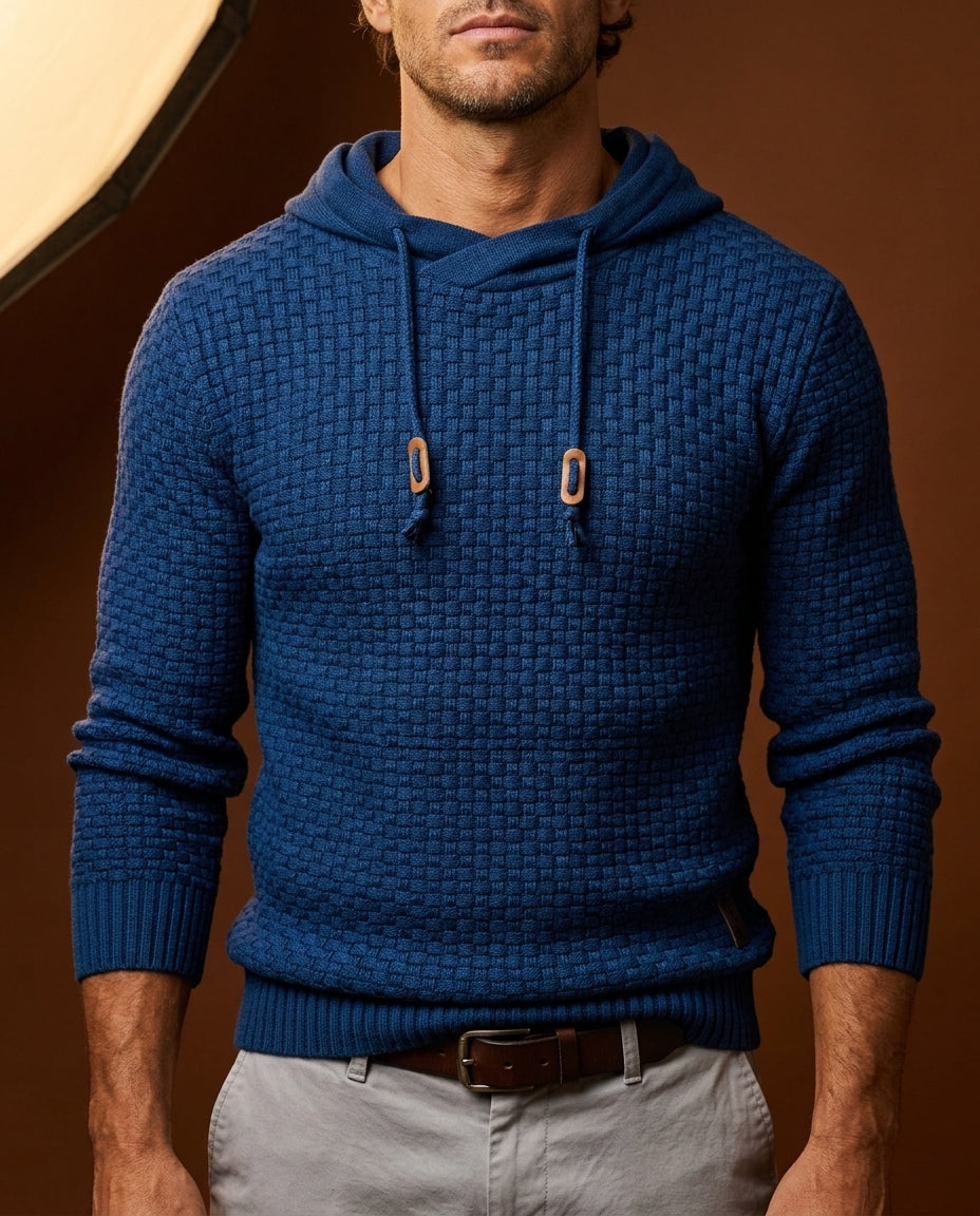 Man wearing navy blue textured knit hooded sweater with wooden toggle drawstrings, close-up front view