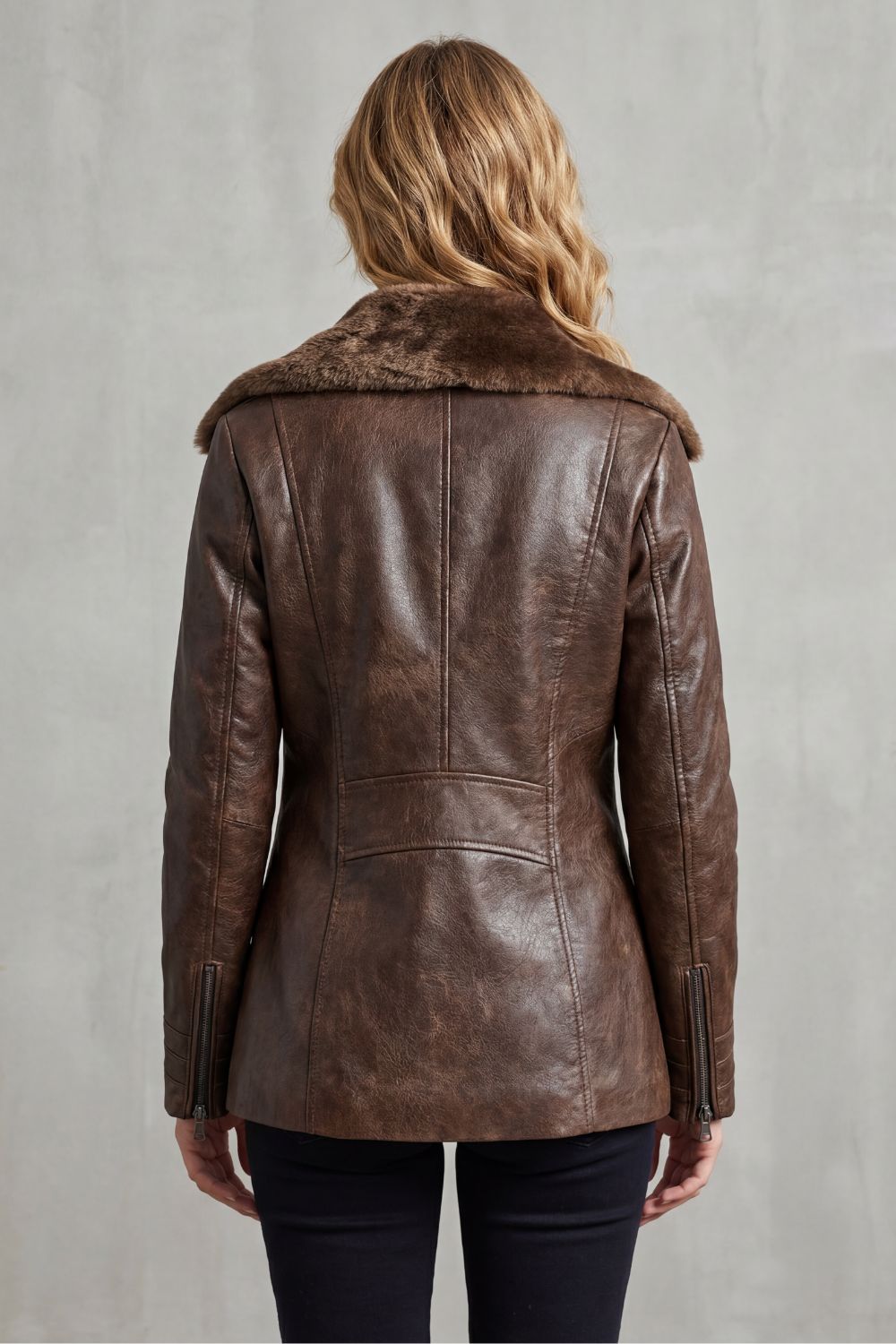 Brown vegan leather jacket with a plush shearling collar and tailored back seams, shown from behind.