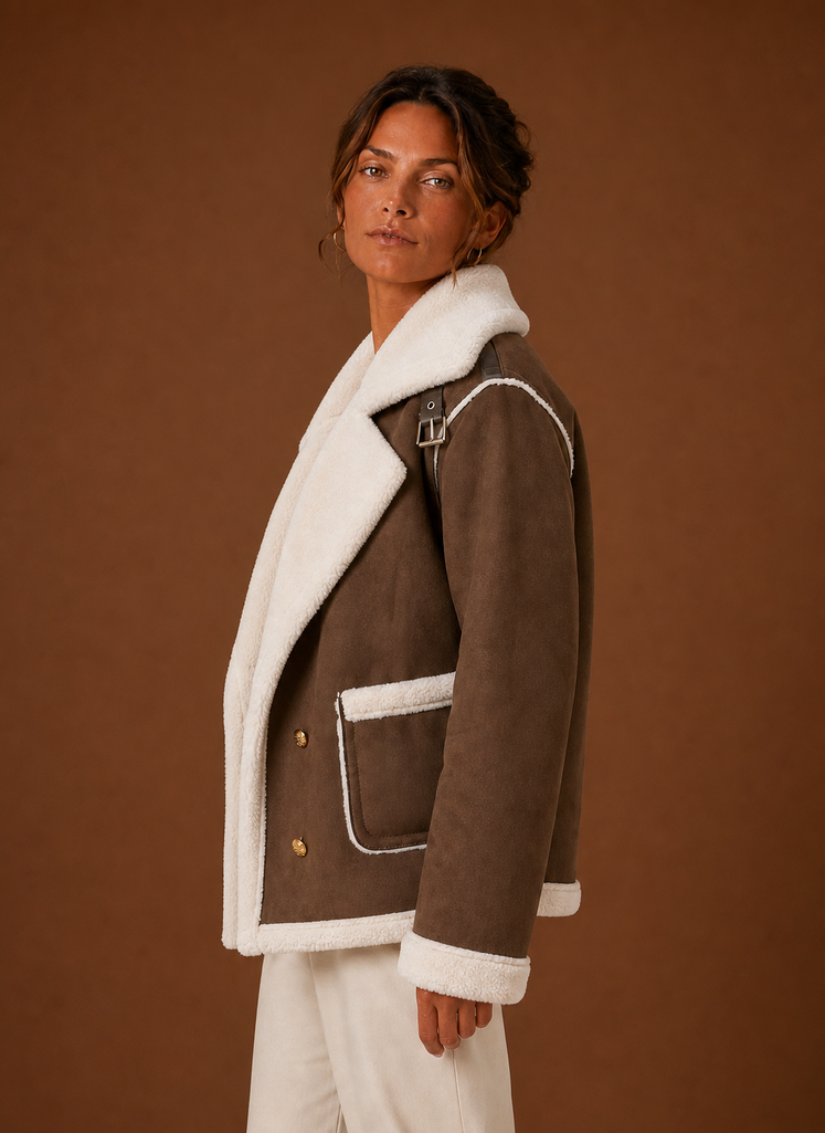 Brown suede-look aviator jacket with plush white sherpa collar, cuffs, and pocket trim in a tailored, layered fit.