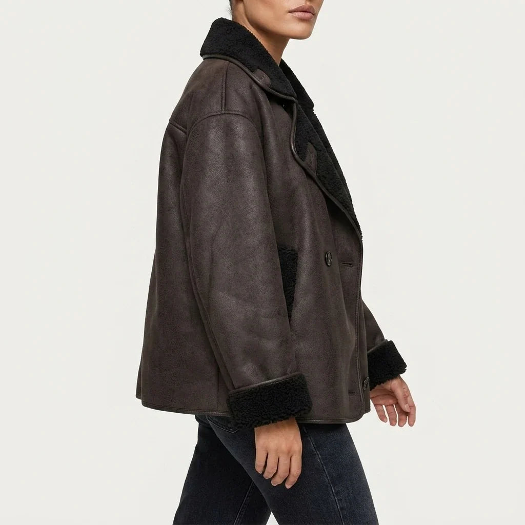 Oversized brown vegan suede jacket with black sherpa lining, double-breasted buttons, and a relaxed fit.