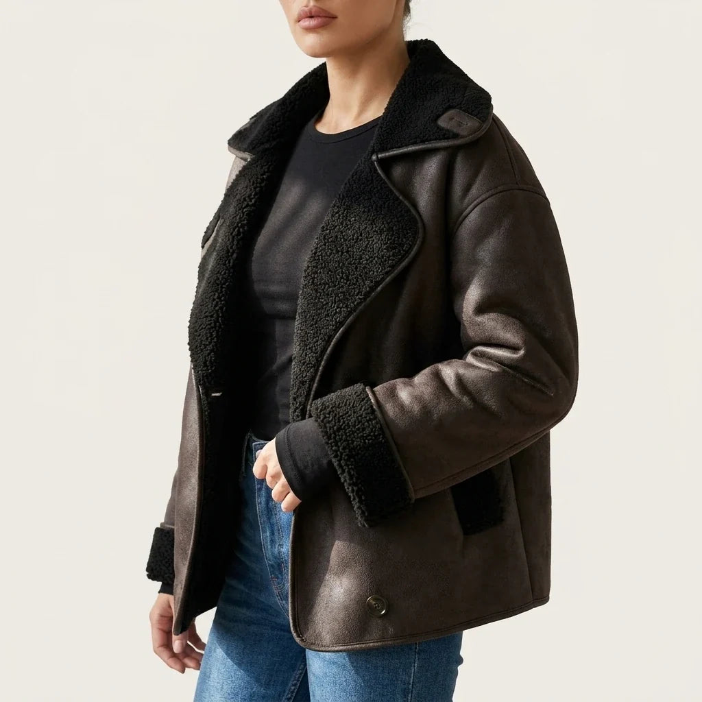 Oversized brown vegan suede jacket with black sherpa lining, double-breasted button front, and relaxed fit.