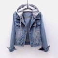 Women's light wash denim jacket with a detachable gray hood, button-front closure, chest flap pockets, and rolled cuffs.