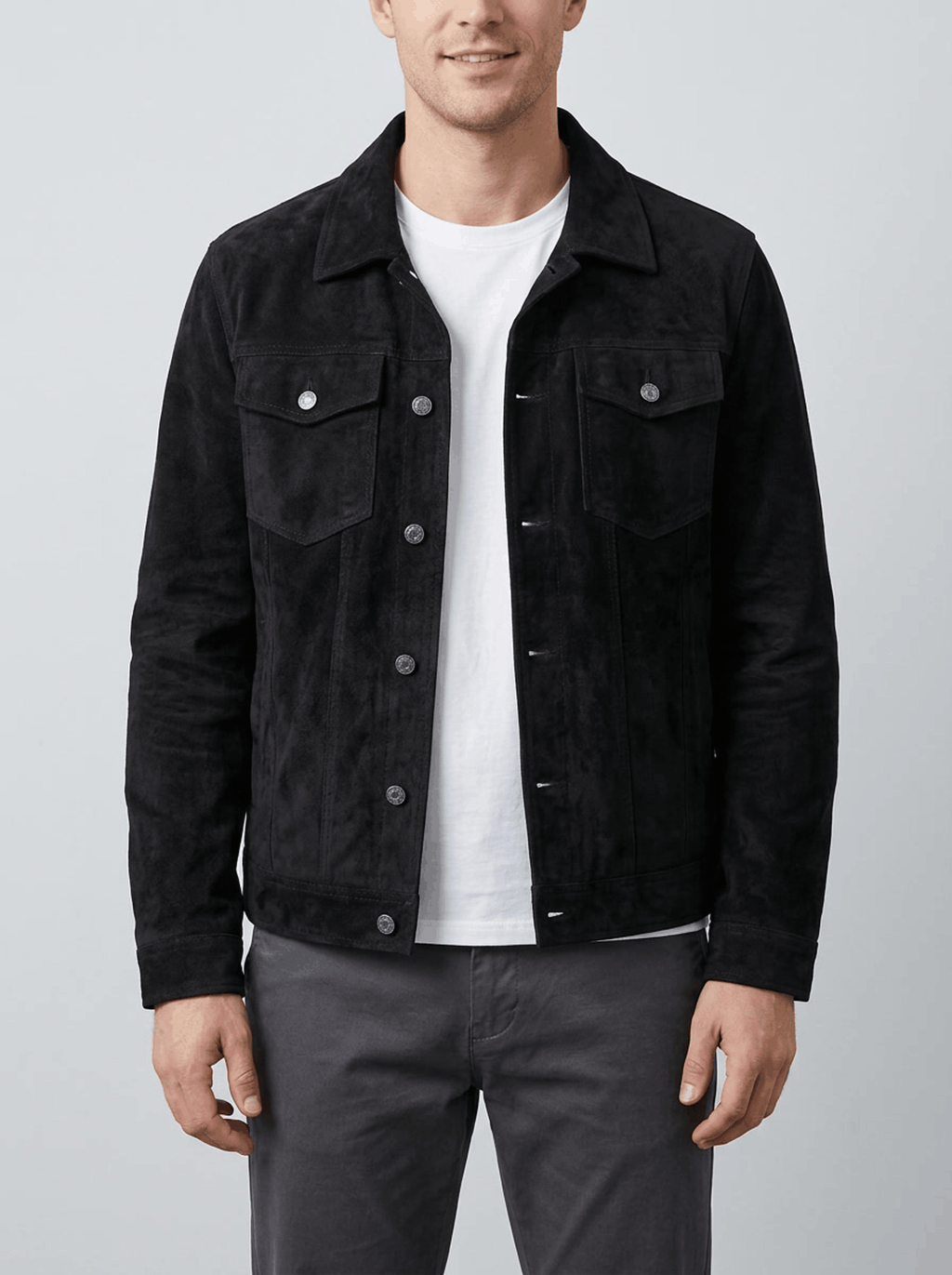 A man wearing a black soft suede jacket with chest pockets and side pockets